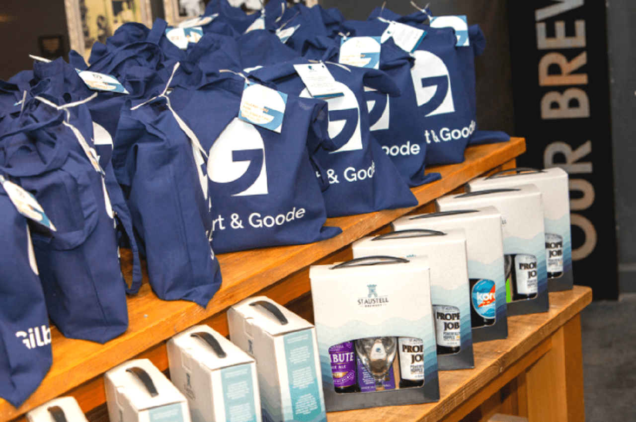 Images for Gilbert & Goode branded goodie bags, and box sets of St Austell Brewery Ales, lined up for the guests parting gifts.