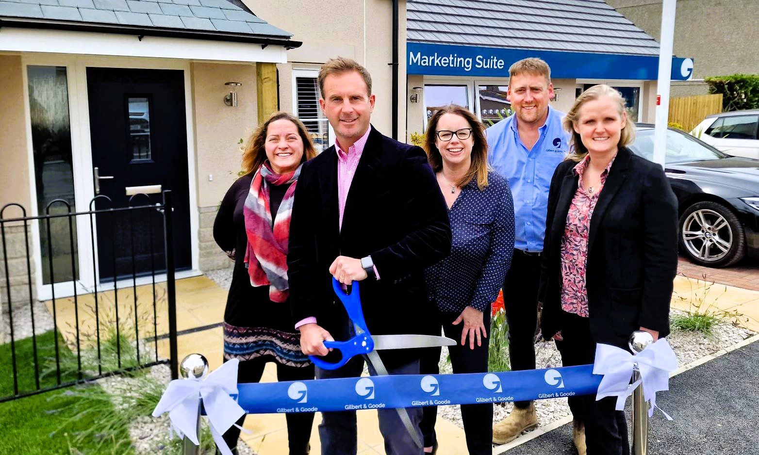 The Gilbert & Goode Tremena View project team stands together, smiling, as they conduct a ribbon-cutting ceremony to mark the opening of the new development.